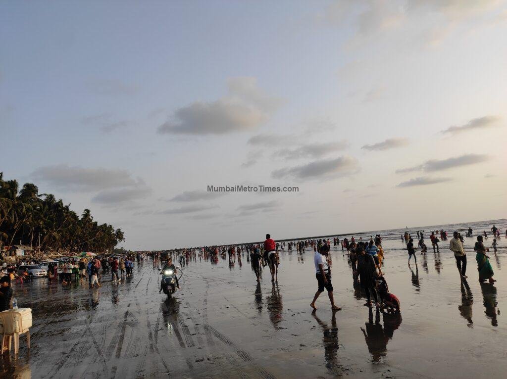 Evening at Gorai Beach with visitors on the sand