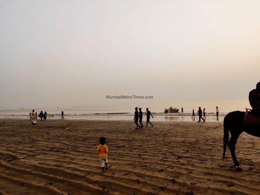 Child running on the sand at Versova Beach